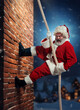 Senior bearded man, Santa Claus climbing upwards the brick wall at night. Entering house through chimney. Concept of winter season, holidays, fantasy, joy and fun, Christmas