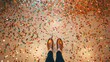 Background floor with shining confetti and legs. Cleaning up after the party