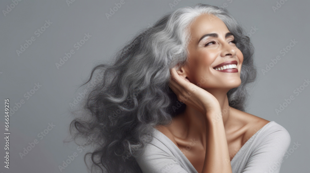 Beautiful smiling mature woman with short gray hair, on a light ...