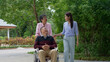 © Prot - A daughter taking care of the patient in a wheelchair and talk with mom. Concept of happy retirement with care from a caregiver and Savings and senior health insurance, Happy family and retirement