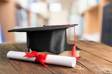 Wall Mural - Graduation cap with on wooden desk in classroom