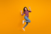 Full Length Photo Of Good Mood Cheerful Person Wear Plaid Shirt Jeans Trousers Jumping Raising Palms Up Isolated On Yellow Background