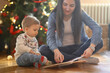© BiljanaMoe - Joyful Christmas Moments: Nanny and Toddler by the Christmas Tree