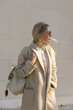 Fashion woman wearing beige coat on the street