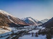 A breathtaking aerial perspective of Livigno, captured with precision from a drone. The sprawling town, nestled amidst the majestic Alps.