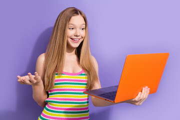 Sticker - Portrait of cheerful teen girl with long hairstyle wear colorful singlet look at laptop on video call isolated on purple background