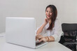 © wichayada - Businesswoman uses laptop to do financial management and calculations, mathematics on white table in office, business management, graphs, tax, accounting, statistics and analytical research concepts.