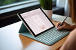© A10zon Studio - Woman's hands writing on the document of tablet mockup with digital planner on screen, soft tones, photorealistic