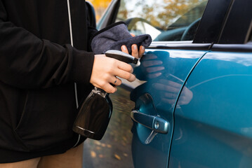 Closeup picture, image young woman, driver, dry wiping her car with microfiber cloth after washing it, cleaning auto, automobile windows. Transportation self service, care concept. Paint protection