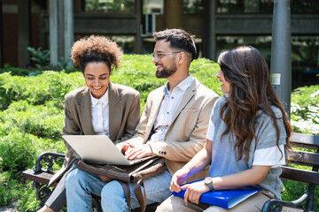 Wall Mural - Group of three young business people experts in marketing telecommuting financial and strategy, talking outside office building. Company workers discussing strategic plans for financial crisis