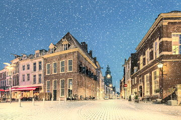 Wall Mural - Dutch winter view with snowfall of the ancient city center of Zutphen, The Netherlands