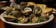 Closeup of a plate of steamed clams. Generative AI.