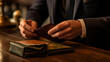 A close-up of a gentleman's hands as he selects a specific card from his open wallet, symbolizing thoughtful financial choices. 