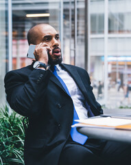 Wall Mural - Bearded African American entrepreneur talking on phone