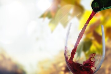 Canvas Print - Pouring tasty alcohol red wine in glass