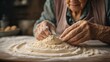 A close-up of an old woman's hand caressing bread dough with her withered, wrinkled fingers
