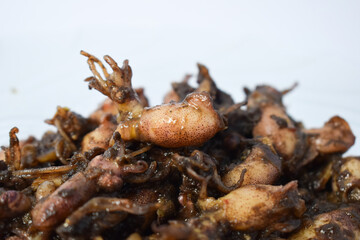 Close up Tumis Cumi, Oseng cumi or Stir Fried Squid placed on tranparent plate of glass isolated on white background. Indonesian food 