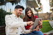 © Minerva Studio - Couple using a tablet outdoors
