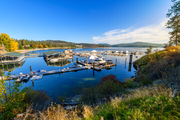 Wall Mural - Panoramic view from the Tubbs Hill hiking trail of the Sanders Beach lakefront community of homes, the sandy beach, and 11th Street Marina along the lake in Coeur d'Alene, Idaho USA at autumn.