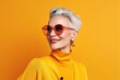 © Thanaphon - Happy elderly woman in colorful Casual outfit Wear sunglasses and an extravagant style. laugh and smile Trendy grandma poses in the studio.