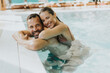 © BGStock72 - Young couple relaxing in the indoor swimming pool