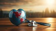 Stethoscope and globe inside heart on a wooden table at sunset