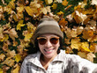 Selfie woman on autumn maple leaves in British Columbia Canada