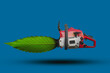 Chainsaw with a leaf from a tree instead of a chain, ecology concept.