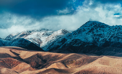 Poster - Picturesque mountain landscape with snowy peaks and clouds