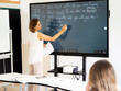 © Jesús de Fuensanta - English teacher using an smart board in a high school.