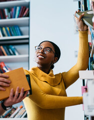 Students choosing books together in library