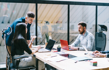 Wall Mural - Concentrated businesspeople collaborating in bright office