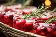 Closeup of a tray of festive holiday tails, garnished with rosemary sprigs, cranberries, and sugared cranberry skewers, adding a touch of elegance to the holiday beverage spread.