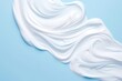 White cosmetic cream lotion moisturizer strokes on blue background