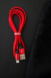 Unoriginal, fake USB-A and Lightning cable, red color on dark background