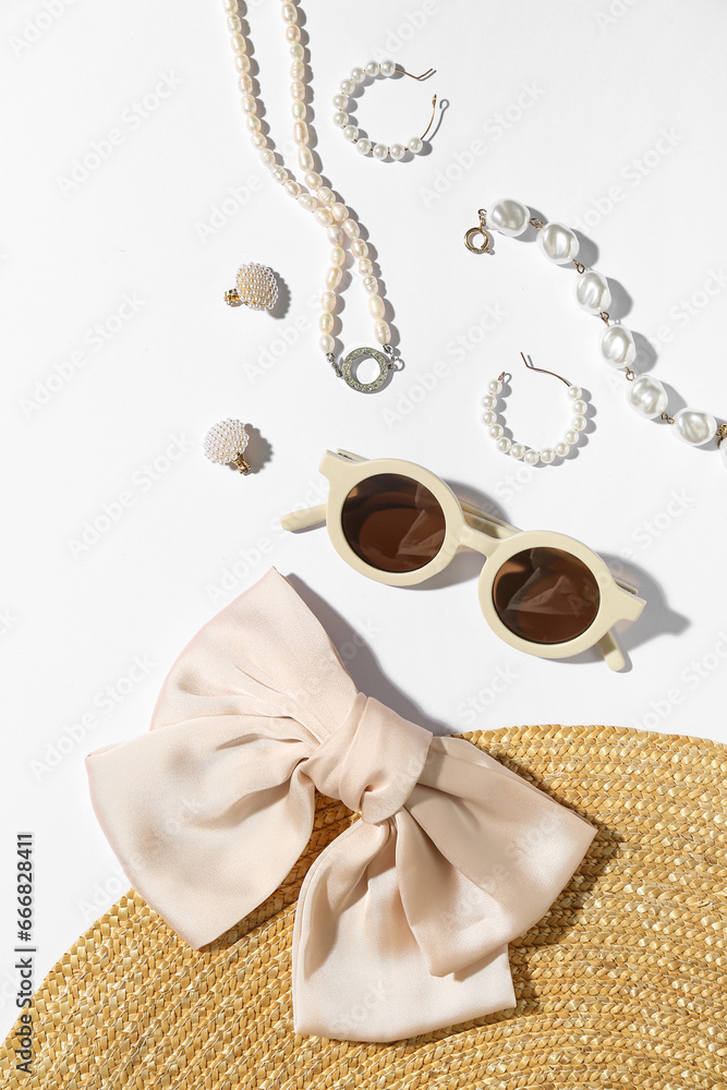 Jewelry with sunglasses and summer hat on white background, closeup