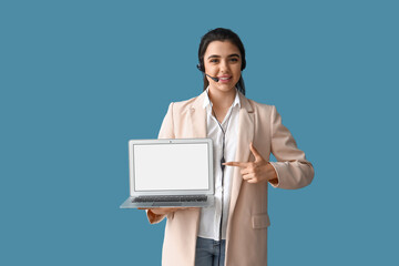 Wall Mural - Female technical support agent with laptop on blue background