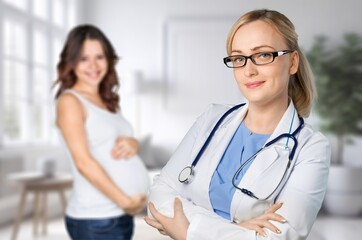 Wall Mural - Happy young pregnant woman with doctor at clinic, AI generated image