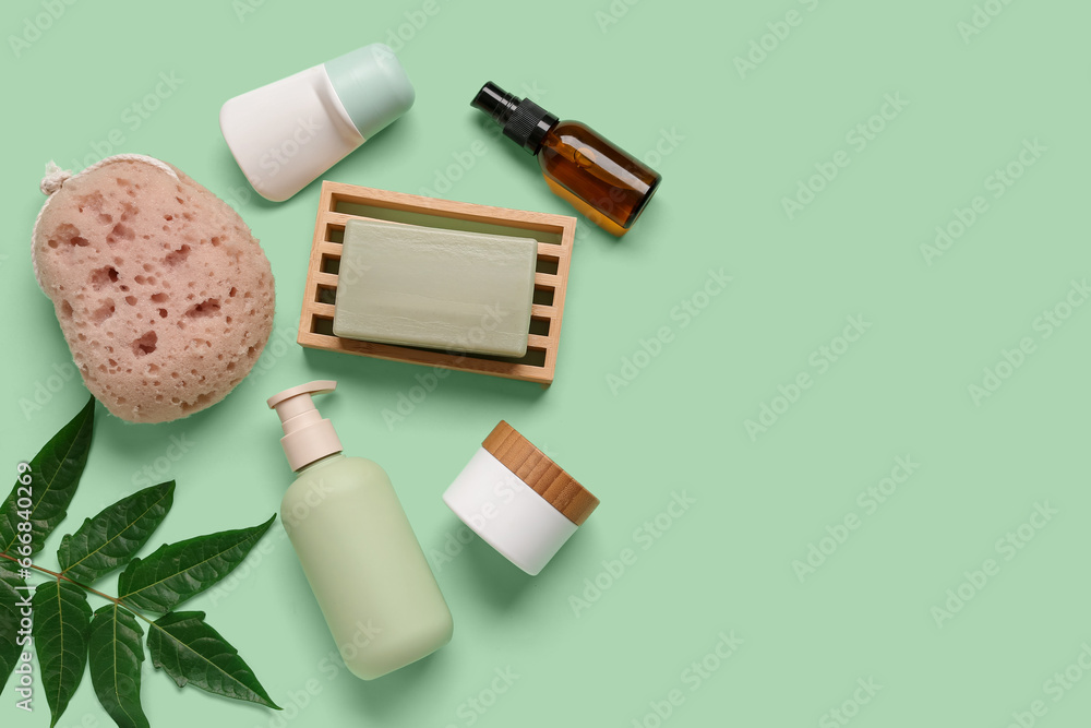Composition with bath supplies and plant leaf on color background