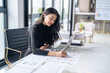 © Charlie's - Beautiful confident asian business woman working with laptop Hands typing  keyboard. Professional investor working new start up project. business planning in office. Technology business