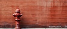 Fire Hydrant By Brick Wall On City Street