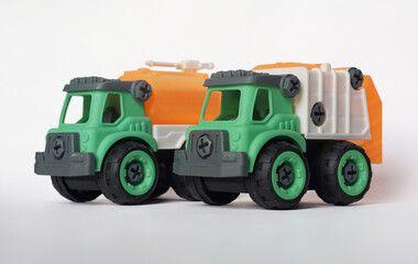 Wall Mural - Two DIY plastic truck toy isolated on white background. water truck and garbage truck.