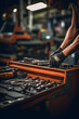 Selective focus on a drawer with auto mechanic's tools with worker fixing car in blurry background at workshop