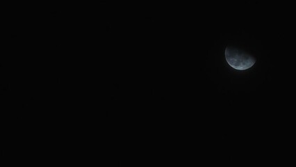 Wall Mural - timelapse of half moon rising in the night sky.