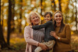 © bernardbodo - Portrait of happy three female generations in the nature