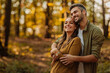 © bernardbodo - Couple in love hugging and walking in the forest