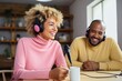 © Georgii - Beautiful multiethnic blogger couple hosting a podcast in a studio. Smiling woman and man wearing headphones sitting at a table with microphones and chatting cheerfully. Modern media technologies.