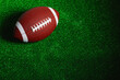 © Nando Vidal - American football ball isolated on green grass