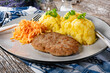 Minced meat cutlet served with mashed potatoes and carrot salad.
