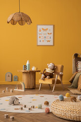 Wall Mural - Warm and cozy kid room interior with mock up poster frame, yellow wall, orange armchair, plush toys, wooden block toys, coffee table, plaid, cup and personal accessories. Home decor. Template.